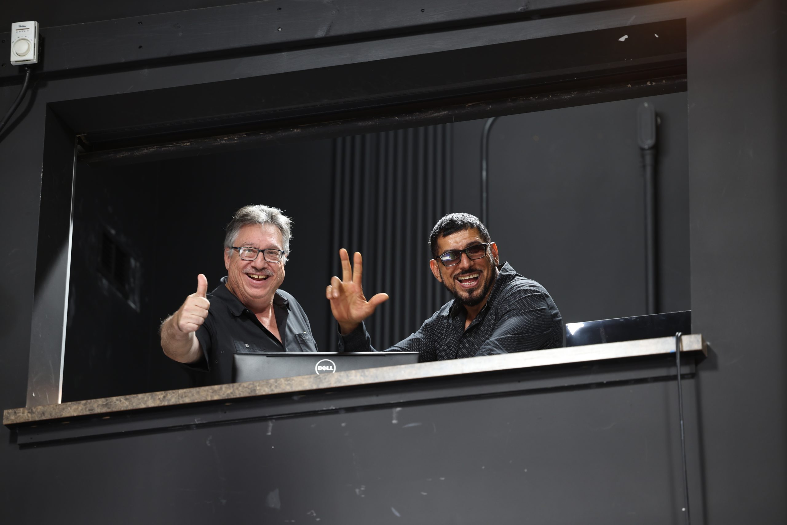 Volunteer smile for the camera from one of our control booths