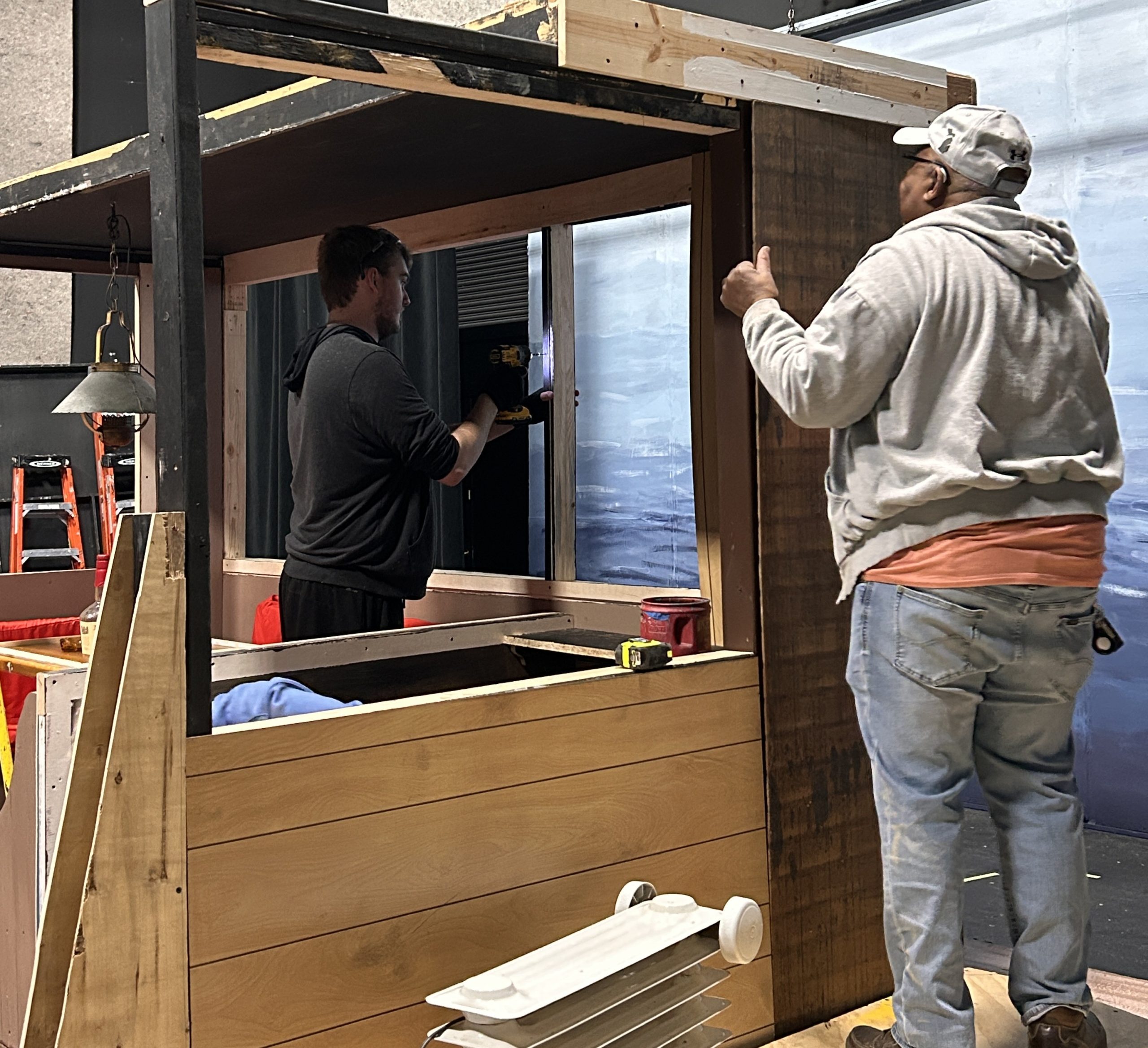 Volunteers work on building a set piece