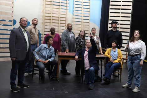 Group photo of the cast on stage.