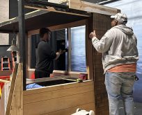 Volunteers work on building a set piece